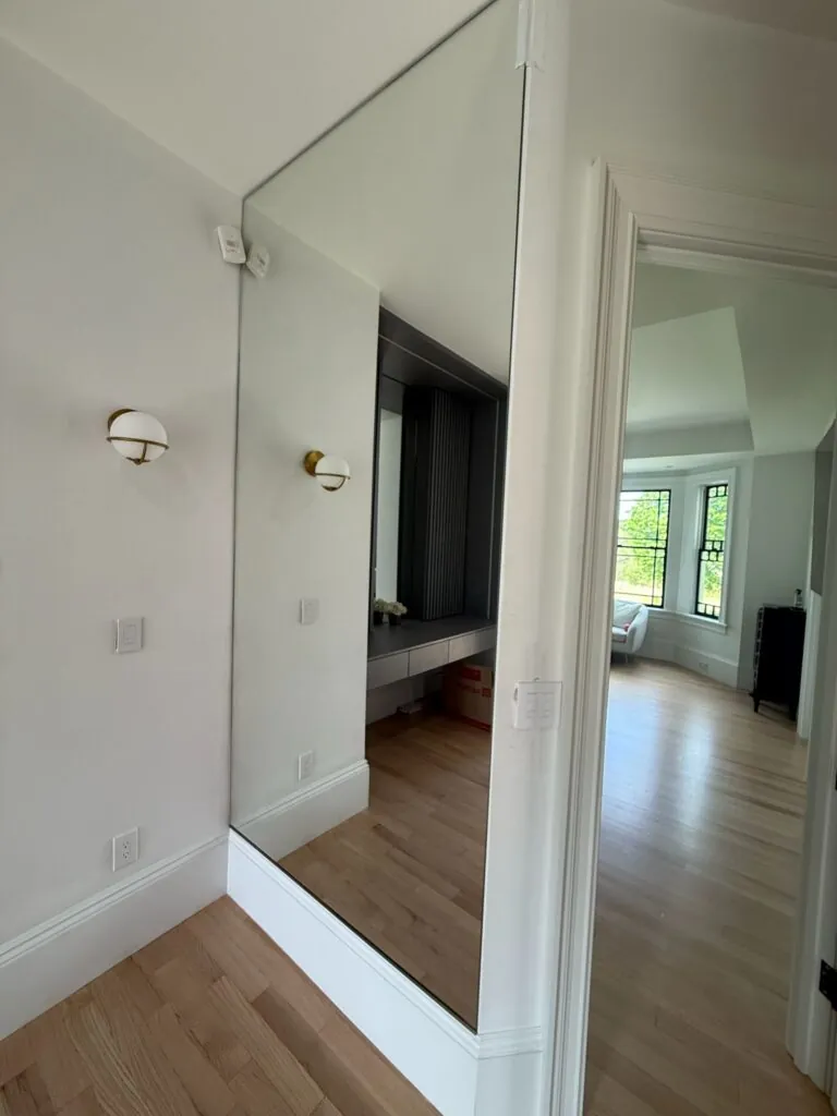 Custom wall mirror in a bright bathroom