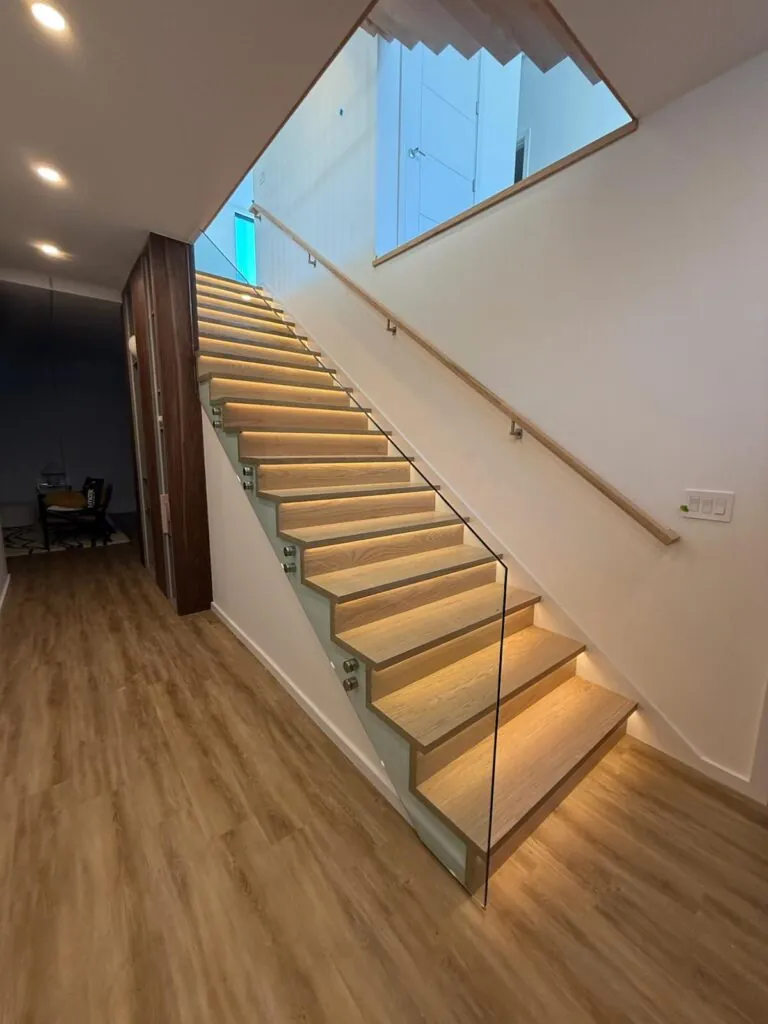 Glass railing panel with metal posts