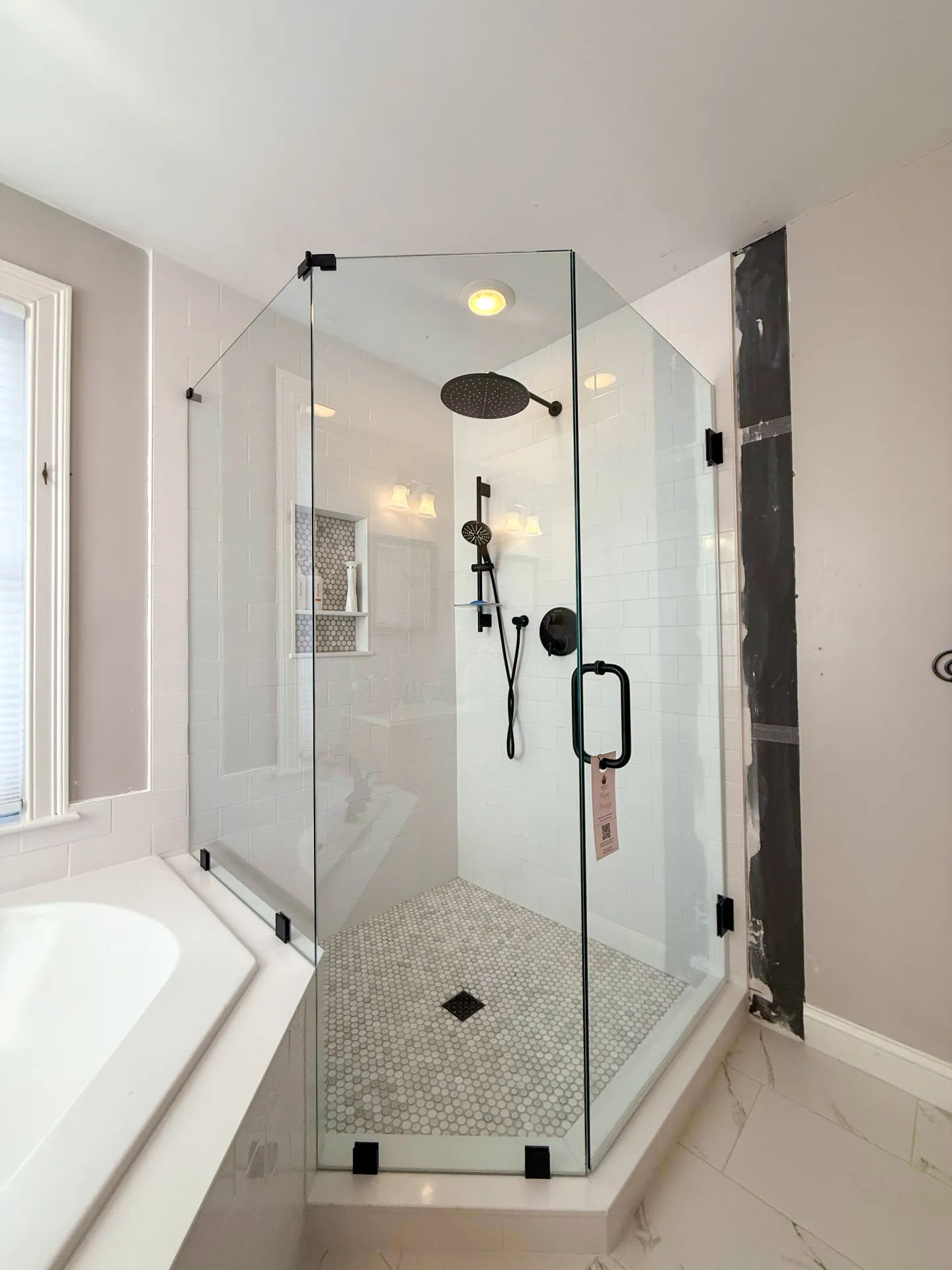 Corner frameless shower door with black hardware
